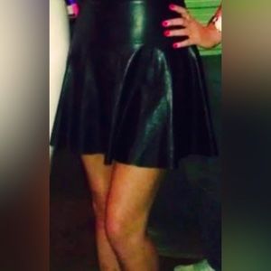 Super hot leather mini skirt with wide waistband and bells out on bottom.